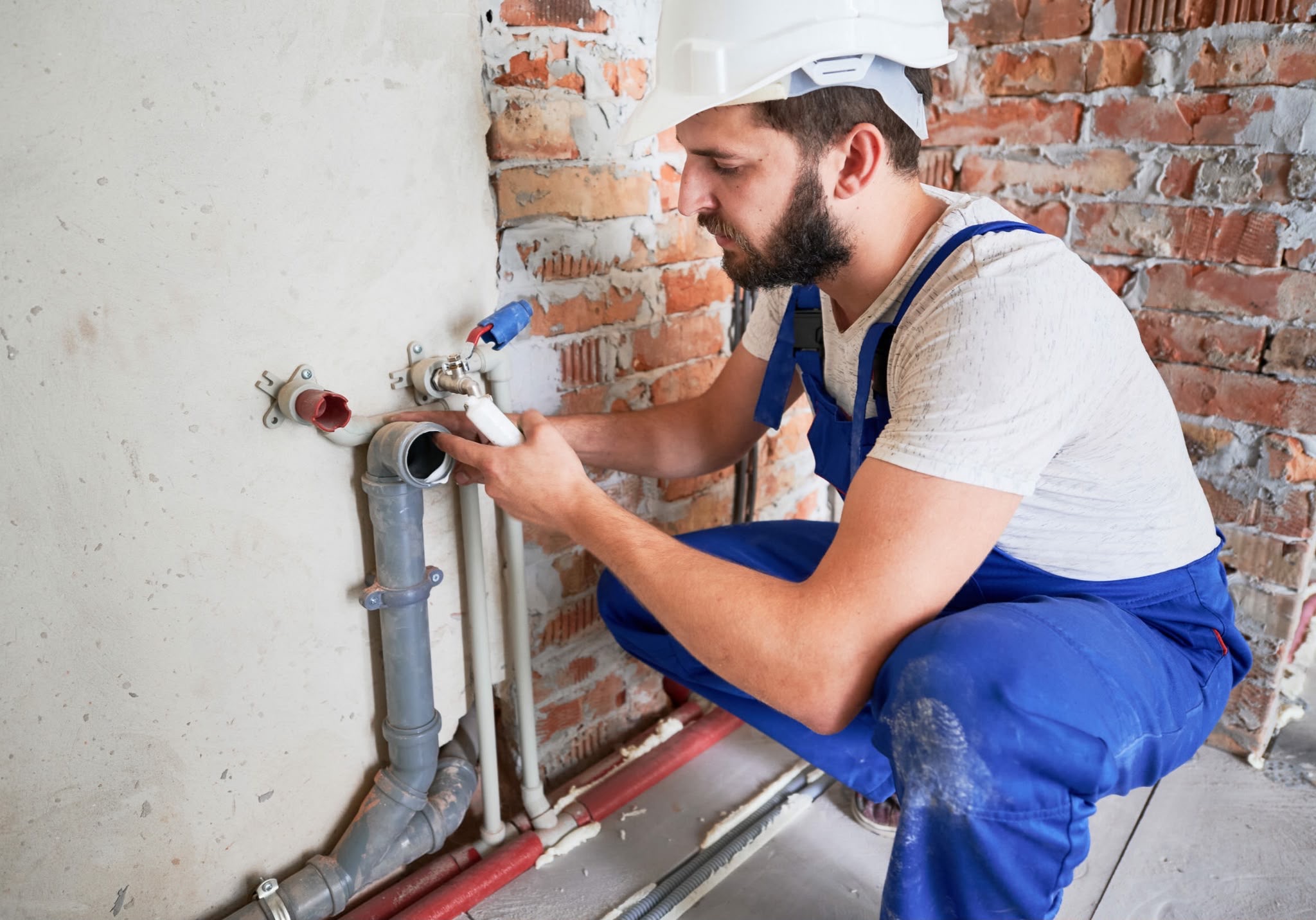 Pipe installation beside a brick wall