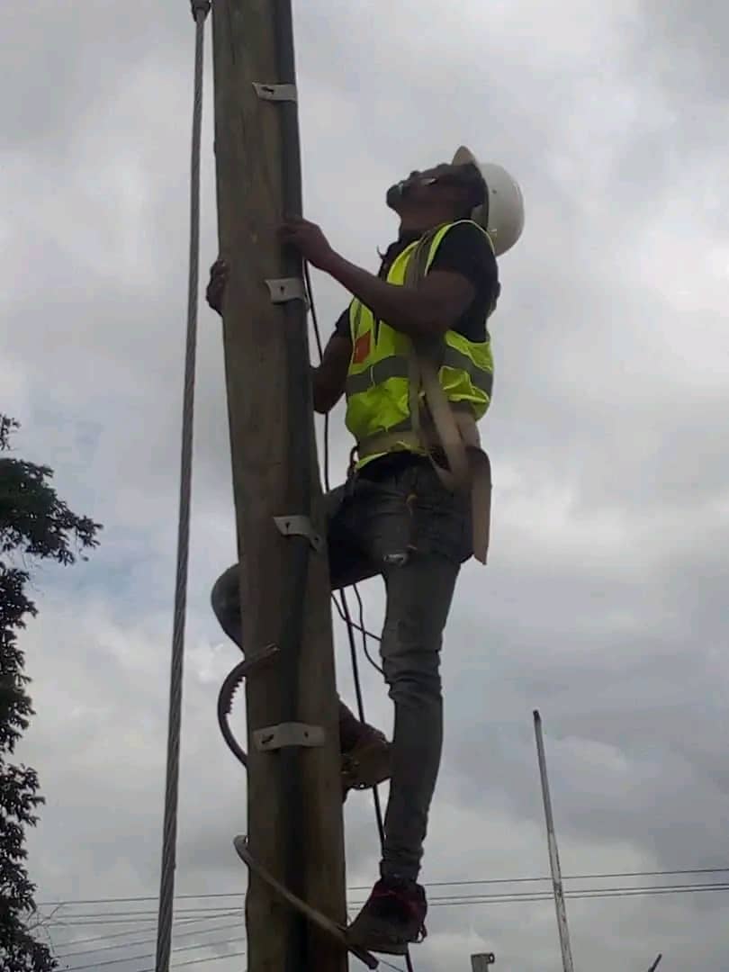 Technician working on a utility pole