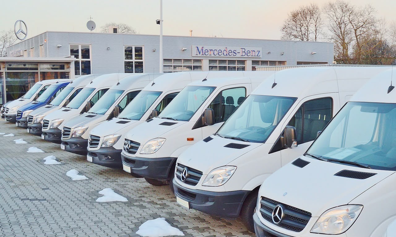 White vans parked outside a building